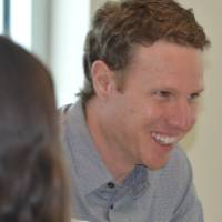 An alumnus smiling at the 30 Minute Mentors Event